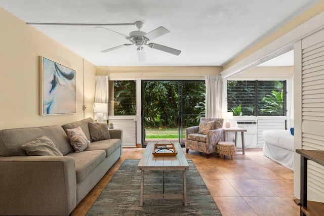 tiled living room with ceiling fan and a textured ceiling