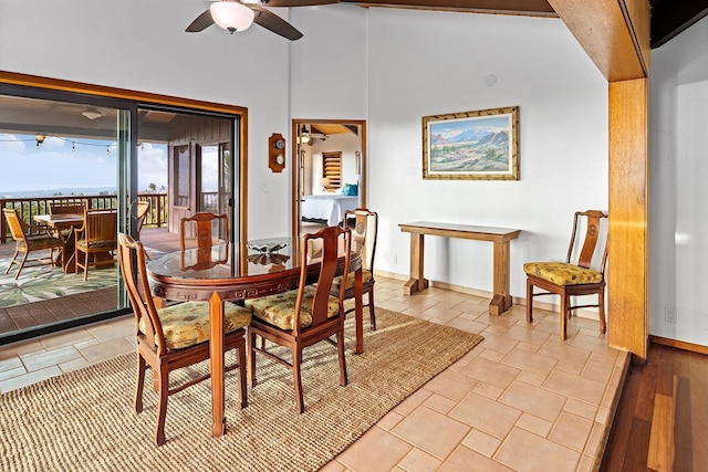 dining space featuring light tile patterned flooring and lofted ceiling