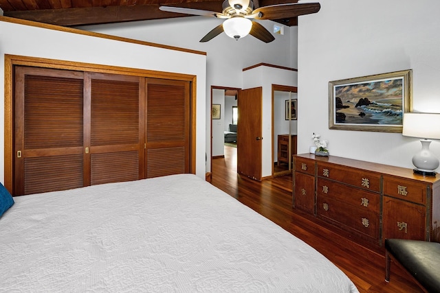 bedroom featuring lofted ceiling with beams, dark hardwood / wood-style flooring, ceiling fan, wooden ceiling, and a closet