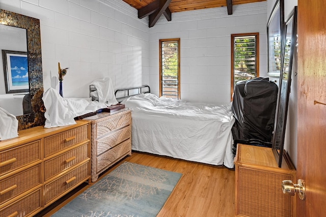 bedroom with vaulted ceiling with beams, wood ceiling, and light wood-type flooring