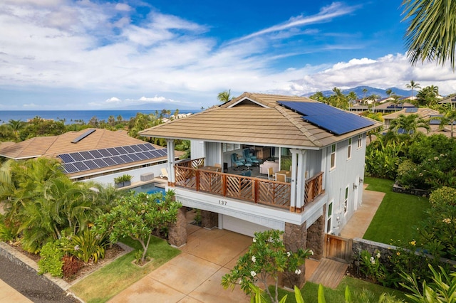 137 Hoohale St, Kihei, HI 96753 - back of property with a balcony, solar panels, a tile roof, driveway, and a garage