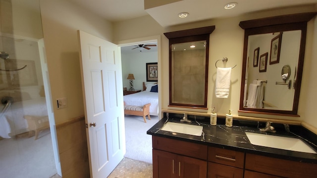 bathroom with a shower, ceiling fan, and vanity