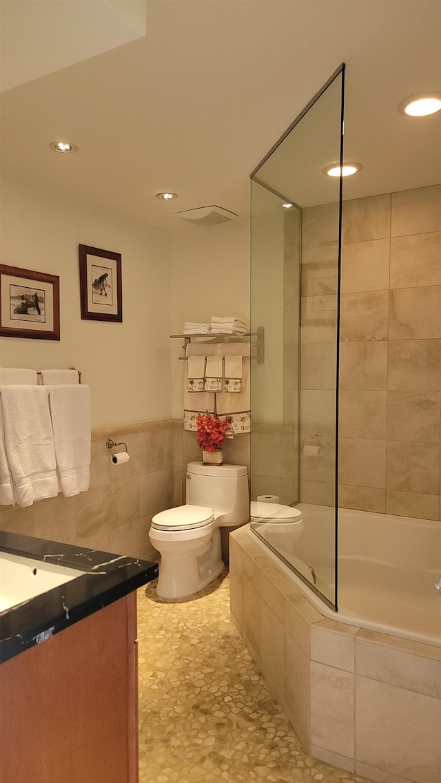 full bathroom featuring shower / bath combination with glass door, vanity, and toilet