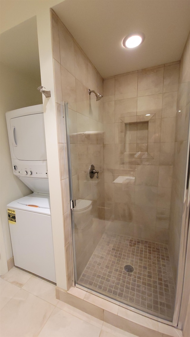 bathroom with tile patterned flooring, toilet, and an enclosed shower