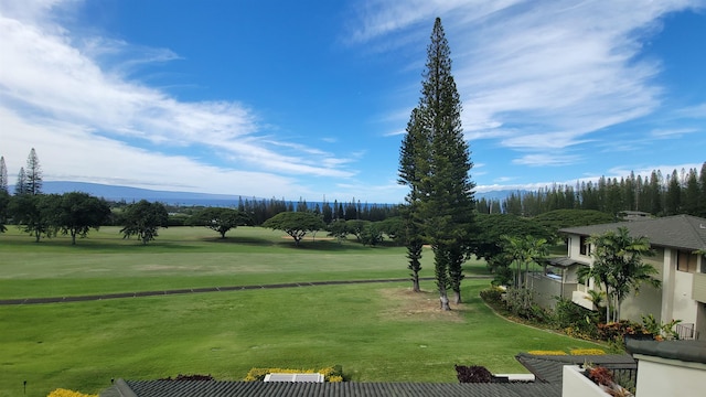 view of community with a mountain view and a yard