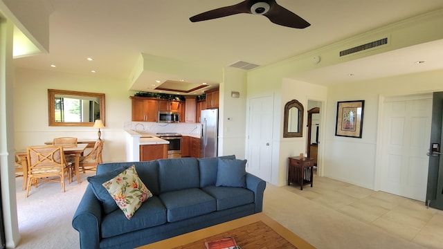 living room with ceiling fan, light tile patterned floors, and ornamental molding