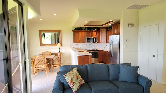 kitchen featuring tasteful backsplash, light carpet, sink, and stainless steel appliances