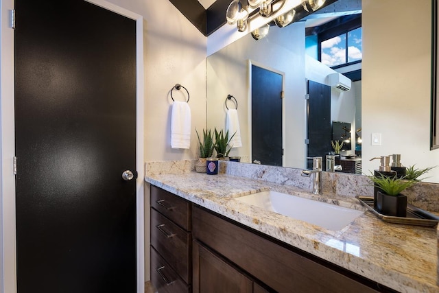 bathroom with vanity and an AC wall unit