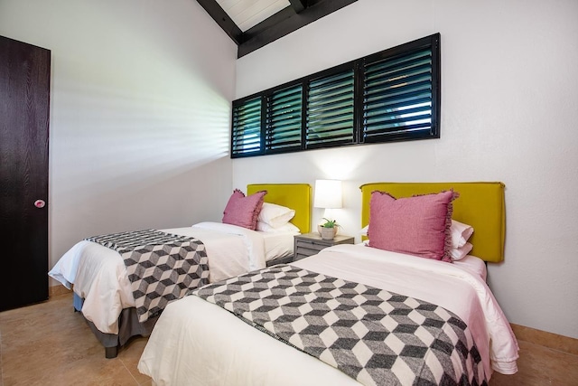 bedroom featuring light tile patterned floors and vaulted ceiling