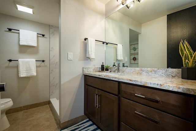 bathroom featuring a shower, tile patterned flooring, vanity, and toilet