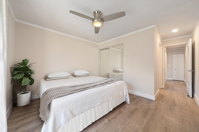 bedroom with ornamental molding, ceiling fan, hardwood / wood-style floors, and a closet