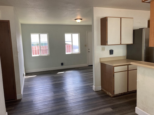 kitchen featuring dark wood-style floors, baseboards, white cabinets, and light countertops
