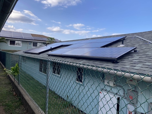 exterior details featuring fence and roof with shingles
