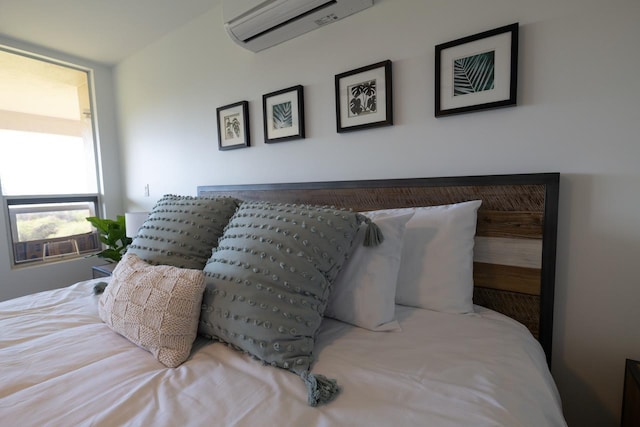 bedroom featuring an AC wall unit