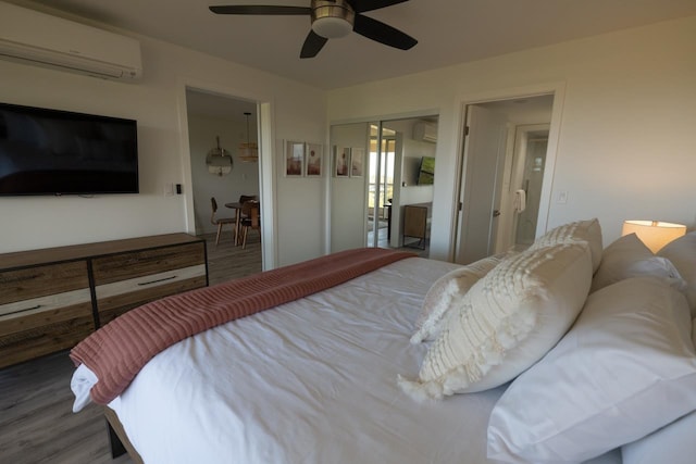 bedroom with dark hardwood / wood-style flooring, a wall mounted AC, and a closet