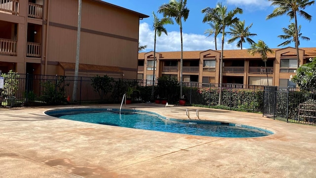 pool featuring a patio and fence