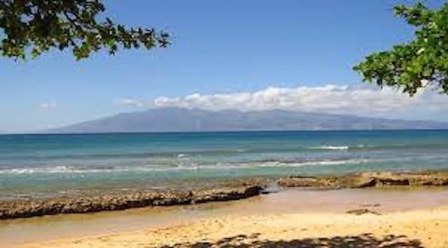 water view featuring a mountain view and a beach view