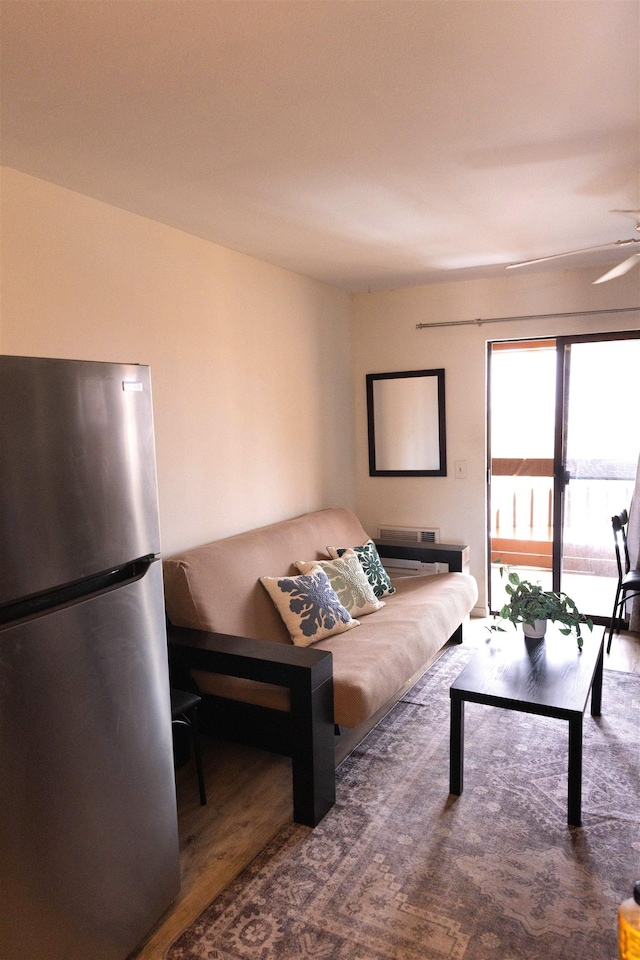 living area featuring wood finished floors and a ceiling fan