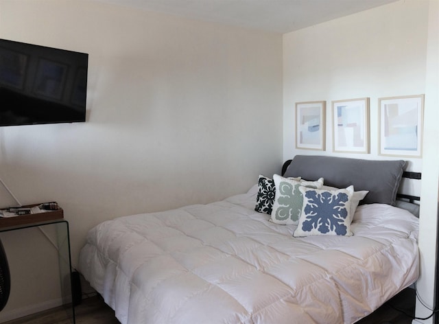 bedroom with wood finished floors