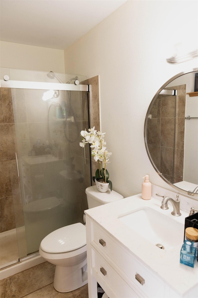 full bath featuring toilet, tile patterned floors, a shower stall, and vanity
