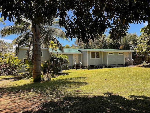 rear view of property featuring a yard