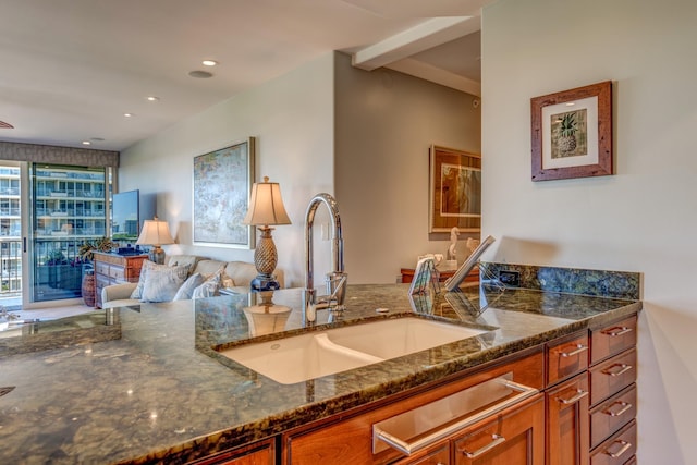 kitchen with sink and dark stone countertops