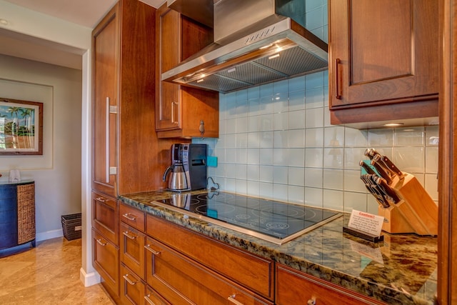 kitchen with backsplash, black electric stovetop, range hood, and dark stone counters