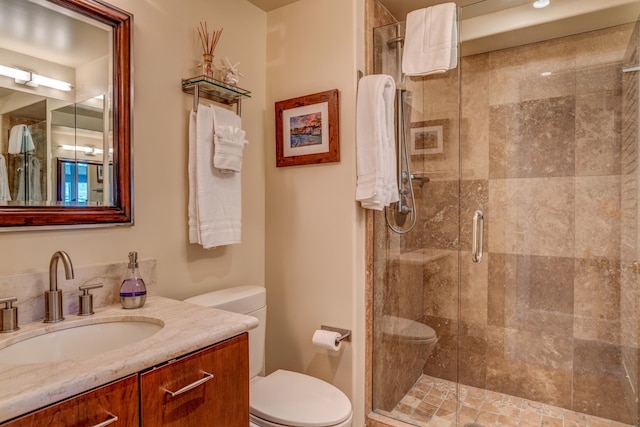 bathroom with vanity, toilet, and walk in shower