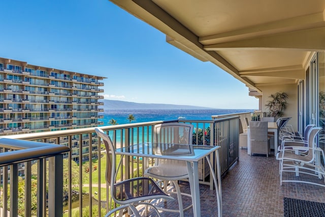 balcony featuring a water and mountain view