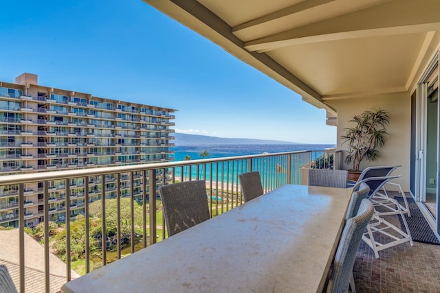 balcony featuring a water and mountain view
