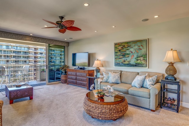 carpeted living room featuring ceiling fan