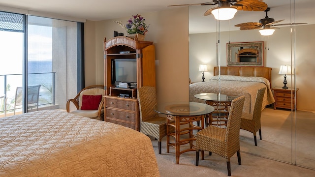 carpeted bedroom featuring ceiling fan and access to outside