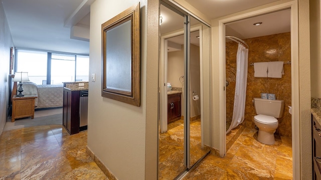 bathroom featuring toilet, tile flooring, and vanity