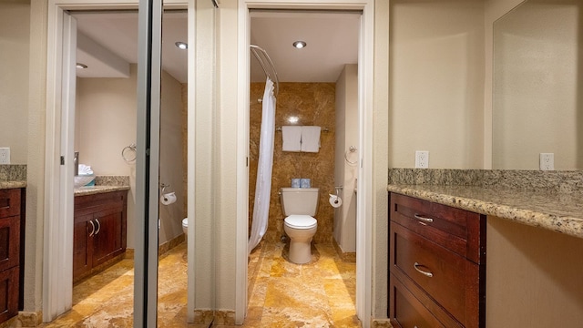 bathroom featuring toilet, tile flooring, and vanity