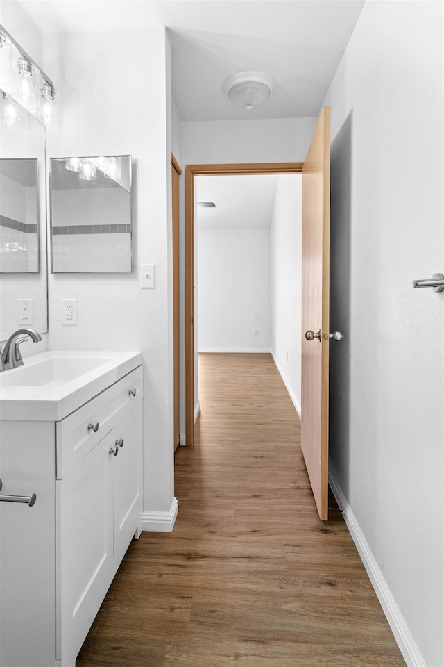 bathroom featuring hardwood / wood-style flooring and vanity