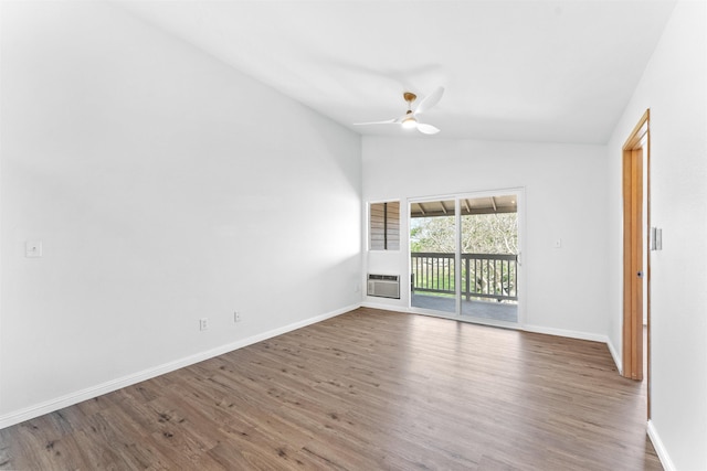 spare room featuring ceiling fan, wood-type flooring, a wall mounted air conditioner, and lofted ceiling