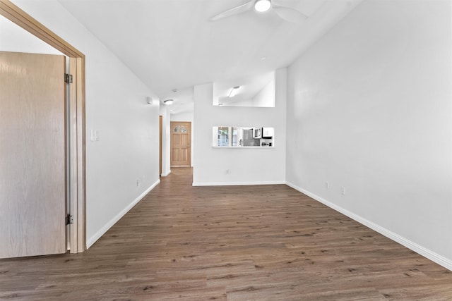 unfurnished living room with dark hardwood / wood-style flooring, vaulted ceiling, and ceiling fan