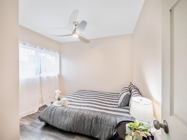 bedroom with ceiling fan and wood-type flooring