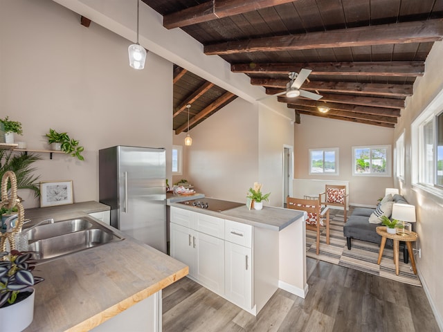 kitchen featuring white cabinetry, hardwood / wood-style floors, decorative light fixtures, and high quality fridge