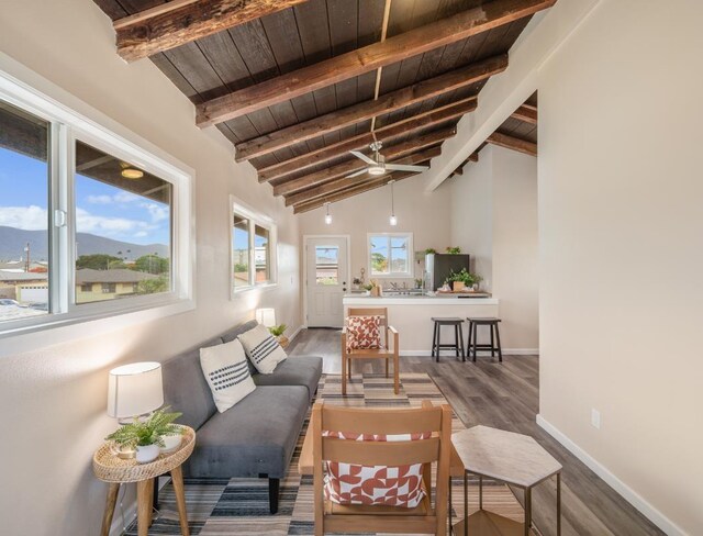 interior space featuring beam ceiling, high vaulted ceiling, dark wood-type flooring, and wooden ceiling