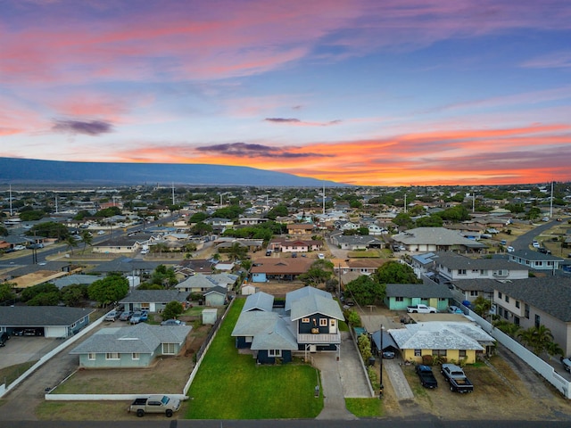 aerial view at dusk featuring a mountain view