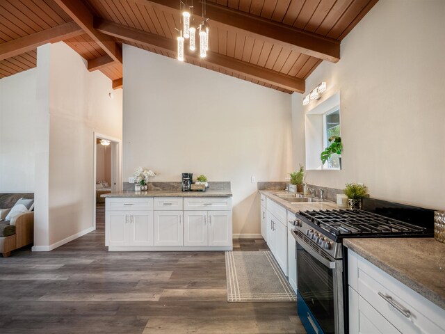 kitchen with white cabinetry, dark wood-type flooring, gas range, hanging light fixtures, and beam ceiling