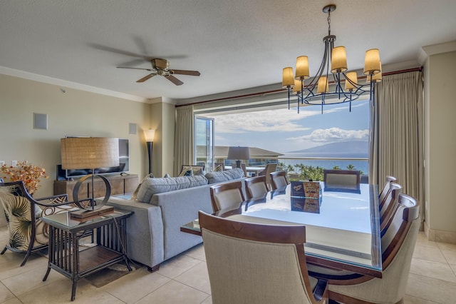 dining area featuring a textured ceiling, ornamental molding, a water view, and light tile patterned floors