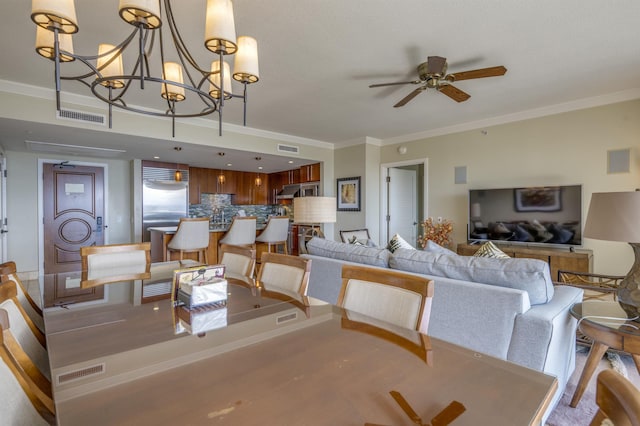 dining room featuring visible vents, crown molding, and ceiling fan with notable chandelier