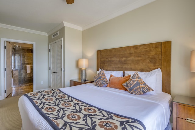 carpeted bedroom with a closet, visible vents, ornamental molding, a ceiling fan, and connected bathroom