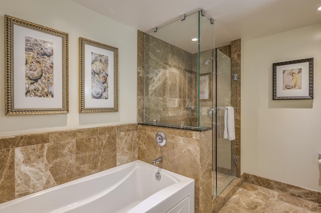 full bathroom with a shower stall, a bath, and recessed lighting