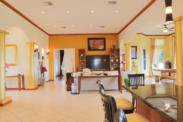 interior space with light tile patterned floors, crown molding, ceiling fan, and ornate columns