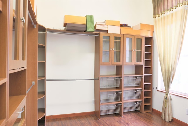 walk in closet featuring dark wood-type flooring