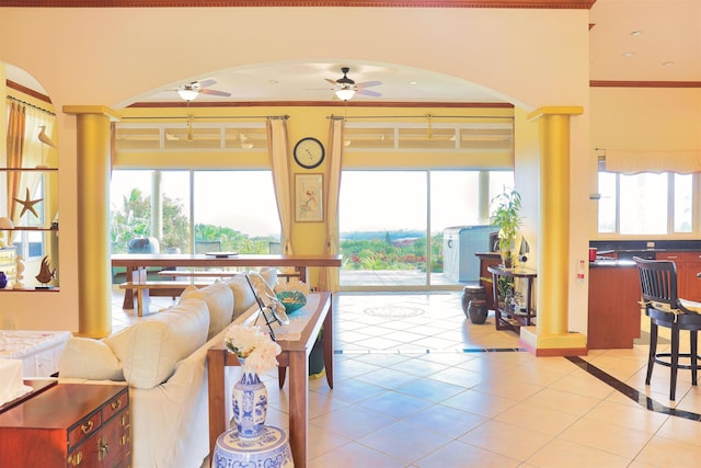 tiled living room featuring a wealth of natural light, ornamental molding, and ceiling fan