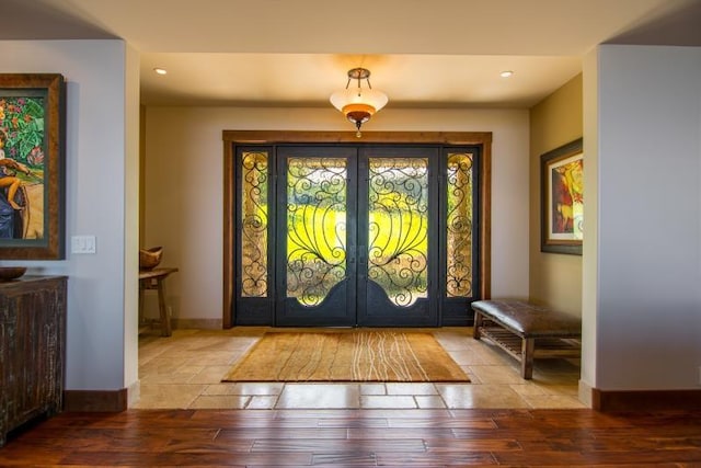 foyer with hardwood / wood-style floors and french doors